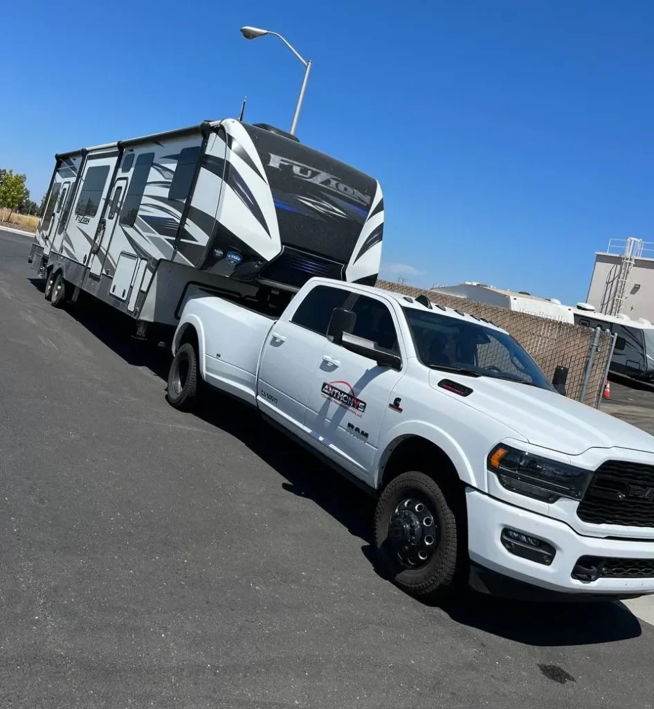 Tow truck providing RV towing Yuba City, safely towing a recreational vehicle on the road